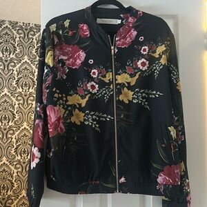 floral jacket with gold, zipper, and elastic sized waistband.